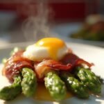 "Bacon-wrapped asparagus with a poached egg on a white plate, under natural morning light"