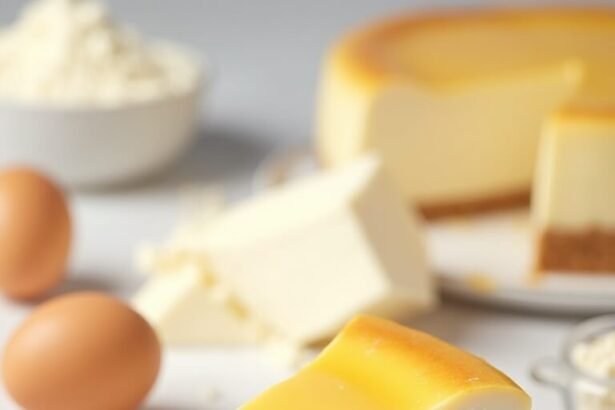 "High-protein Greek yogurt cheesecake slice on a white plate with cream cheese, vanilla protein powder, and key ingredients around on a marble surface"