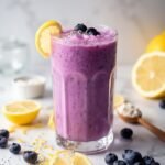 "Lemon blueberry protein smoothie with fresh ingredients on a marble background"
