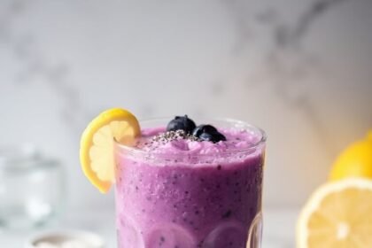 "Lemon blueberry protein smoothie with fresh ingredients on a marble background"