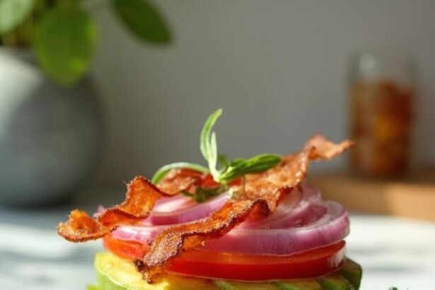 "Overhead shot of a bunless burger with beef patty, melted cheddar, avocado, tomato, and bacon nestled between lettuce and a grilled portobello mushroom cap on a clean marble countertop"