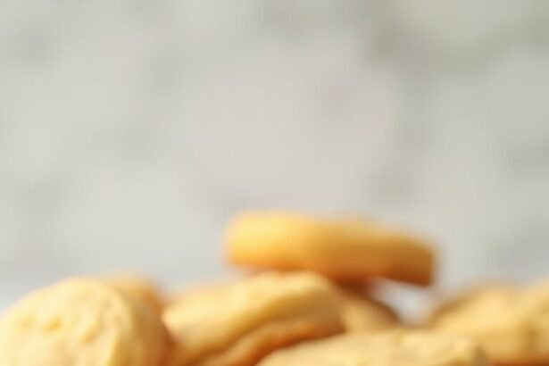 "Freshly baked keto sugar cookies with almond and coconut flour on a clean white marble background, subtly steaming and glowing under soft natural light."