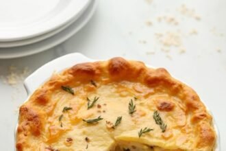 "Golden-brown low-carb chicken pot pie with almond flour crust on a clean marble surface"