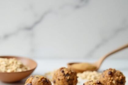 "No-bake protein energy balls with oats, peanut butter, and chocolate chips on a marble surface"