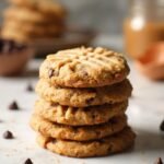 "Stack of almond butter keto cookies with chocolate chips on a clean marble background"