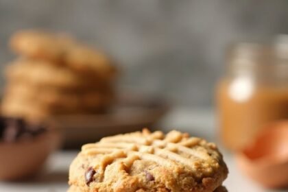 "Stack of almond butter keto cookies with chocolate chips on a clean marble background"