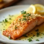 "Crispy Parmesan Crusted Salmon Fillet on White Ceramic Plate with Lemon Wedges and Fresh Parsley"