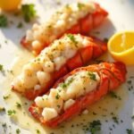 "Garlic butter lobster tails with herbs and lemon on a clean white marble background"