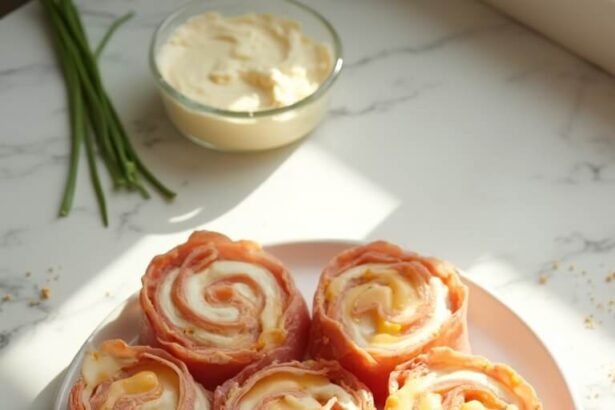 "Overhead view of keto ham and cheese roll-ups with cream cheese and garlic seasoning on white marble counter"